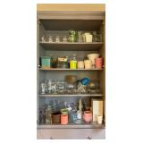 Bellevue Estate Sale cabinet filled with glassware vases planters and decorative pieces.