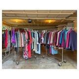 Racks of colorful vintage clothing jackets dresses and suits at a Bellevue Estate Sale.