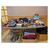 Office supplies notebooks electronics and travel bags at a Bellevue Estate Sale.