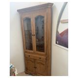 Corner Tall glass-front oak display cabinet