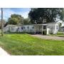 Affordable Investment Opportunity with 2 Bed Mobile Home, 3 Car Garage & City Lot
