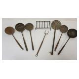 1017	GROUP OF PRIMITIVE WROUGHT IRON KITCHEN ITEMS INCLUDING LADLES, STRAINERS, FORK, SMALL TRIVET, 