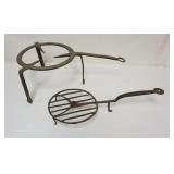 1018	PRIMITIVE WROUGHT IRON FIREPLACE TRIVETS, ONE ROTATING, LARGEST APPROXIMATELY 26 IN X 14 IN X 9