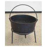 1026	LARGE CAST IRON CAULDRON ON IRON STAND, APPROXIMATELY 22 IN X 14 IN HIGH