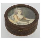1002	ANTIQUE TRINKET BOX W/HAND PAINTED PORTRAIT UNDER GLASS, APPROXIMATELY 3 1/2 IN X 1 1/2 IN					