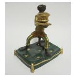 1033	CAST METAL HAND PAINTED MONKEY ON PILLOW CANDLESTICK, APPROXIMATELY 6 IN X 5 IN X 8 IN HIGH				