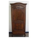 1192	CONTINENTAL CARVED OAK NARROW ONE DOOR CABINET W/LOWER DRAWER, FLORAL CARVING AT CREST & CENTER