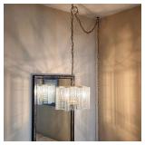 Vintage hanging light with textured glass panels, displayed beside a tall decorative wall mirror