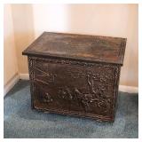 Brass repoussé coal box with decorative raised scenes and hinged lid — vintage fireplace accessory.