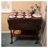 Vintage drop-leaf serving table with lower shelf, displayed with Danish gold-interior cups and sauce
