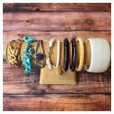 Vintage costume bracelets and bangles in assorted colors, textures and decorative styles.