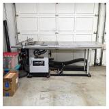 Delta Unisaw cabinet table saw with extension table and rip fence.
