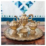 Sterling silver coffee/tea service with tray, creamer, covered sugar and shell bowl; acquired in Tax