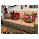 Beige leather sofa, decorative pillows, 