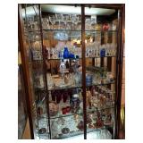 glass Curio Cabinet filled with crystal stemware and decoratives