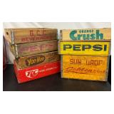 Six Vintage Wooden Soda Crates Featuring Various Beverage Brands