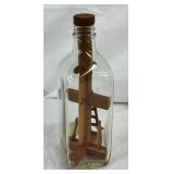 Handcrafted Wooden Cross Displayed Within a Glass Bottle with Stopper