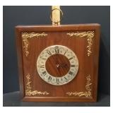 Mid Century Square Wooden Wall Clock Featuring A White Roman Numeral Dial And Gold Corner Accents – 
