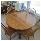 Round Oak Dining Table with Claw Foot Base & Four Spindle-Back Chairs