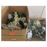 Wide variety of artificial flowers and leaves in a basket