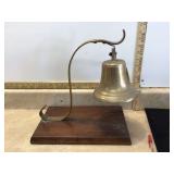 Brass bell mounted on wooden plaque