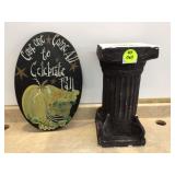 Decorative wall plaque with an integrated column for plant display