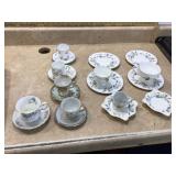 Variety of decorative teacups with matching saucers