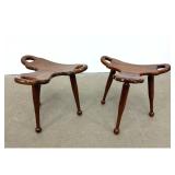 Lot 711  Pair of sculptural hardwood tripod stools with tri lobed seats and ball feet. Marbella style.