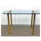 Lot 757  Mid-Century Modern brass toned metal and demilune glass console table. Unsigned.