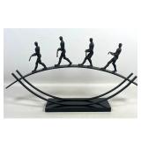 Lot 828  GLOBAL VIEWS Contemporary Cast Metal 4 Tightrope Walker Sculpture. Balancing Act. Black Stone Plinth