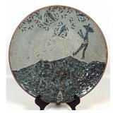 Lot 901  Artist Signed Stoneware Charger. Figure on mountain. 