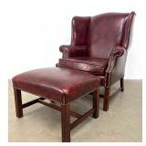 Lot 1089  Classic Leather Inc. Wingback Lounge Armchair and Matching Ottoman in Oxblood Leather. Signed with L