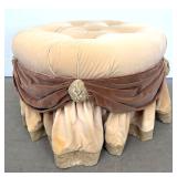 Lot 1090  Hollywood Regency Tufted Velvet Round Ottoman. Draped Swag Detail with Rosettes. Brass Ball Casters