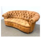 Lot 1218  Curved tan leather Chesterfield kidney sofa Couch featuring deep diamond button tufting and brass to