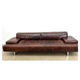 Lot 1219  Modern low profile 3 seat sofa in distressed brown leather with polished chrome sled legs. Unsigned.